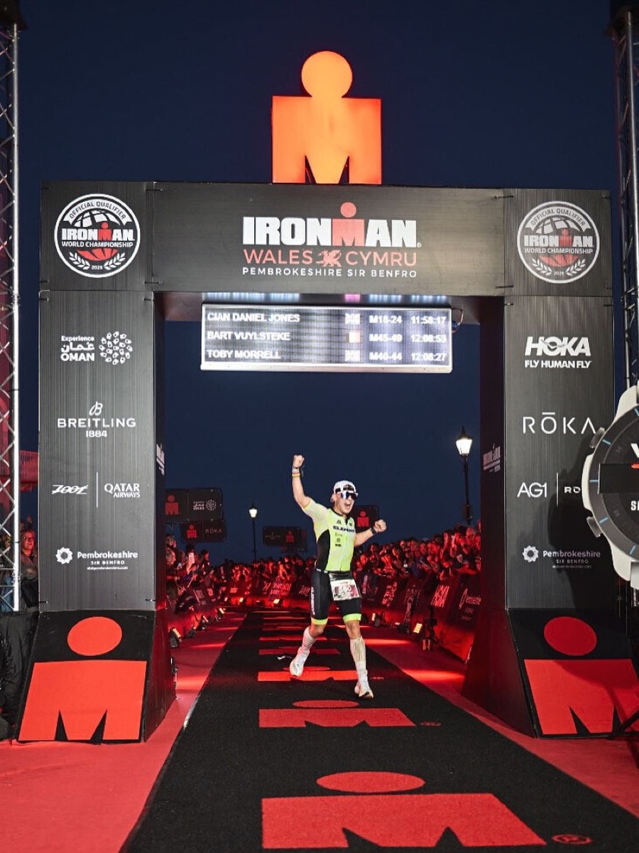 Cian Daniel Jones crossing the finish line at Ironman Wales 2025