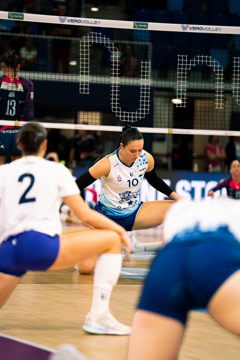 Federica Piacentini, number 10 for Il Bisonte Volley Firenze, stretching at the net before a match